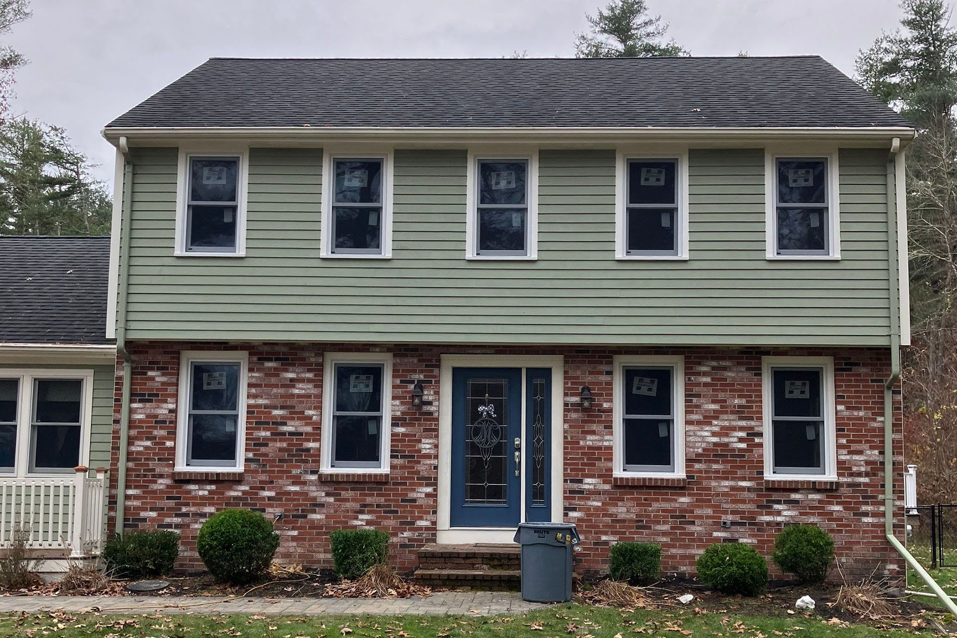 Home with blue siding and white windows